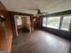 Living room with wood paneling, dark floors, and large windows at 1016 Rock Springs St, Forest Park, GA 30297