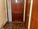 Front entry with wood door and stone tile floor at 907 Strawberry Ct, Ellenwood, GA 30294