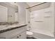 Bathroom featuring granite vanity top and shower/tub combo at 2576 Godfrey Nw Dr, Atlanta, GA 30318