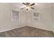 Bright bedroom with 2 windows, gray carpet, and ceiling fan at 2576 Godfrey Nw Dr, Atlanta, GA 30318