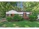 Classic brick home featuring a well-manicured lawn and tasteful landscaping for enhanced curb appeal at 2576 Godfrey Nw Dr, Atlanta, GA 30318