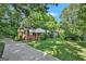 Quaint brick home featuring a walkway, green lawn, and a driveway leading to the residence at 2576 Godfrey Nw Dr, Atlanta, GA 30318