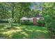 Charming brick home with a well-maintained lawn and mature trees in a serene, wooded setting at 2576 Godfrey Nw Dr, Atlanta, GA 30318