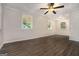 Spacious living room with hardwood floors, large windows, and a modern ceiling fan at 2576 Godfrey Nw Dr, Atlanta, GA 30318