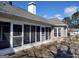 Brick home exterior showing the screened in back porch with white trim and a wooden deck at 0 Hawkins Academy Rd, Social Circle, GA 30025