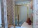 Bathroom with a glass-enclosed shower, a toilet and floral wallpaper at 0 Hawkins Academy Rd, Social Circle, GA 30025