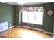 Bedroom featuring a large window providing bright natural light, hard wood floors and green walls at 0 Hawkins Academy Rd, Social Circle, GA 30025