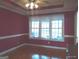 Bright dining room featuring hardwood floors and natural light from the large window at 0 Hawkins Academy Rd, Social Circle, GA 30025