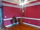 Traditional dining room with red walls, light wood floors, and elegant crown molding at 0 Hawkins Academy Rd, Social Circle, GA 30025