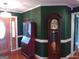 Open entryway with dark green walls, white trim, hardwood floors, and a wooden curio cabinet at 0 Hawkins Academy Rd, Social Circle, GA 30025