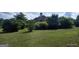 A sprawling green lawn surrounds this home, partially obscured by lush trees and foliage at 0 Hawkins Academy Rd, Social Circle, GA 30025