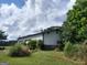Side view of building with metal siding, features lush green landscaping, including trees and shrubs surrounding the property at 0 Hawkins Academy Rd, Social Circle, GA 30025
