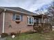 Charming brick home featuring a window box, sunroom window, and a wooden deck overlooking a tranquil view at 0 Hawkins Academy Rd, Social Circle, GA 30025
