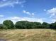 Expansive field with trees in the background, perfect for recreation, offering space and privacy for various activities at 0 Hawkins Academy Rd, Social Circle, GA 30025