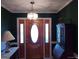 Well-lit front foyer featuring an oval-shaped glass-paneled front door, paneled walls, and modern light fixture at 0 Hawkins Academy Rd, Social Circle, GA 30025