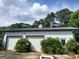 Large garage with two doors and a white exterior, surrounded by green shrubs and a well-maintained lawn at 0 Hawkins Academy Rd, Social Circle, GA 30025