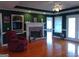 A spacious living room featuring a fireplace, built-in shelving, hardwood floors, and access to the back porch at 0 Hawkins Academy Rd, Social Circle, GA 30025