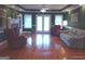 A spacious living room featuring a brick fireplace, large windows, hardwood floors, and comfortable seating at 0 Hawkins Academy Rd, Social Circle, GA 30025
