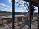 A view from a screened porch through the screen showing a lake and trees in the background at 0 Hawkins Academy Rd, Social Circle, GA 30025