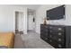 View of the main bedroom showing large dresser with a flat screen TV and ensuite doorway at 7013 Old Bridge Ln, Conyers, GA 30013