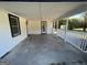 Spacious side porch with concrete flooring and white railings at 171 Plantation Dr, Fayetteville, GA 30215