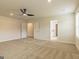 Spacious bedroom with neutral carpeting, ceiling fan, and doors leading to a bathroom and walk-in closet at 1613 Fuma Leaf Way # 273, Mcdonough, GA 30253
