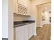 Hallway featuring a butler's pantry, hardwood floors and granite countertop at 1613 Fuma Leaf Way # 273, Mcdonough, GA 30253