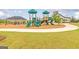 Community playground featuring slides, play structures, a covered picnic area, and well-maintained landscaping at 1613 Fuma Leaf Way # 273, Mcdonough, GA 30253