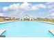 Community pool and pergola surrounded by lounge chairs and lush landscaping, perfect for summer relaxation at 1613 Fuma Leaf Way # 273, Mcdonough, GA 30253