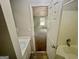 This bathroom features a white door, a white sink and shower at 110 Peridot Pl, South Fulton, GA 30349
