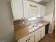 The kitchen has an undermount sink, tile backsplash, and a window for natural light at 110 Peridot Pl, South Fulton, GA 30349