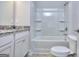 Bright bathroom featuring a white vanity with granite countertop and a shower-tub combo with modern fixtures at 6116 Ripple Way # 47, South Fulton, GA 30349