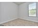Bright bedroom with carpet flooring, white trim, and a large window with blinds at 6116 Ripple Way # 47, South Fulton, GA 30349