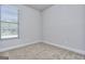 Bright bedroom with carpet flooring, white trim, and a large window with blinds at 6116 Ripple Way # 47, South Fulton, GA 30349