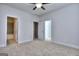 A carpeted bedroom featuring a ceiling fan and multiple entryways to the bathroom and closet at 6116 Ripple Way # 47, South Fulton, GA 30349