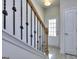 Bright entryway with wood-look flooring, staircase, and white doors at 6116 Ripple Way # 47, South Fulton, GA 30349