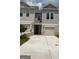Charming townhome with attached garage, modern siding, and concrete driveway at 6116 Ripple Way # 47, South Fulton, GA 30349