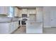 Modern kitchen with stainless appliances, granite counters and center island at 6116 Ripple Way # 47, South Fulton, GA 30349