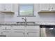 Modern kitchen features granite countertops, stainless steel appliances, and white cabinets at 6116 Ripple Way # 47, South Fulton, GA 30349