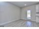 Bright, open-concept living space with wood-look flooring and door to backyard at 6116 Ripple Way # 47, South Fulton, GA 30349