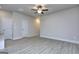 Spacious living room featuring a ceiling fan, wood-look flooring and neutral paint at 6116 Ripple Way # 47, South Fulton, GA 30349
