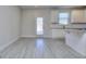 Bright living room showing kitchen features white cabinets and stainless appliances at 6116 Ripple Way # 47, South Fulton, GA 30349