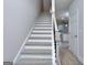 View of the stairway and banister leading to upper floor at 6116 Ripple Way # 47, South Fulton, GA 30349