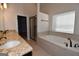 Elegant bathroom with double vanity, soaking tub, and glass shower at 329 Rays Ct # 12, Grayson, GA 30017