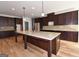 Kitchen boasts a large island, granite countertops, and dark wood cabinets at 329 Rays Ct # 12, Grayson, GA 30017