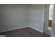 Cozy bedroom features neutral walls and carpet with an open doorway to the bathroom at 207 Millwheel Dr, Villa Rica, GA 30180
