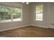 Sunlit bedroom featuring wood floors, neutral walls, and a large window with tree views at 207 Millwheel Dr, Villa Rica, GA 30180