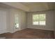 Well-lit bedroom with neutral walls, carpet, a large window, and a door to the backyard at 207 Millwheel Dr, Villa Rica, GA 30180