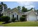 Charming one-story home with a manicured front yard and attached garage in a suburban neighborhood at 207 Millwheel Dr, Villa Rica, GA 30180