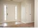 Inviting foyer with neutral walls, tile flooring, and a stylish front door with sidelights at 207 Millwheel Dr, Villa Rica, GA 30180